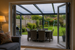View from inside a British family home looking out onto an anthracite grey PolycarbonateX lean-to roof with clear multiwall polycarbonate sheets over a patio.